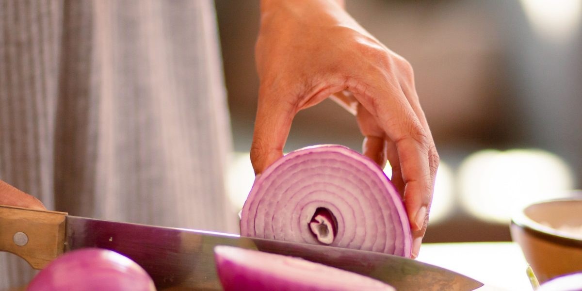 Person preparing a kidney-friendly meal in a bright kitchen